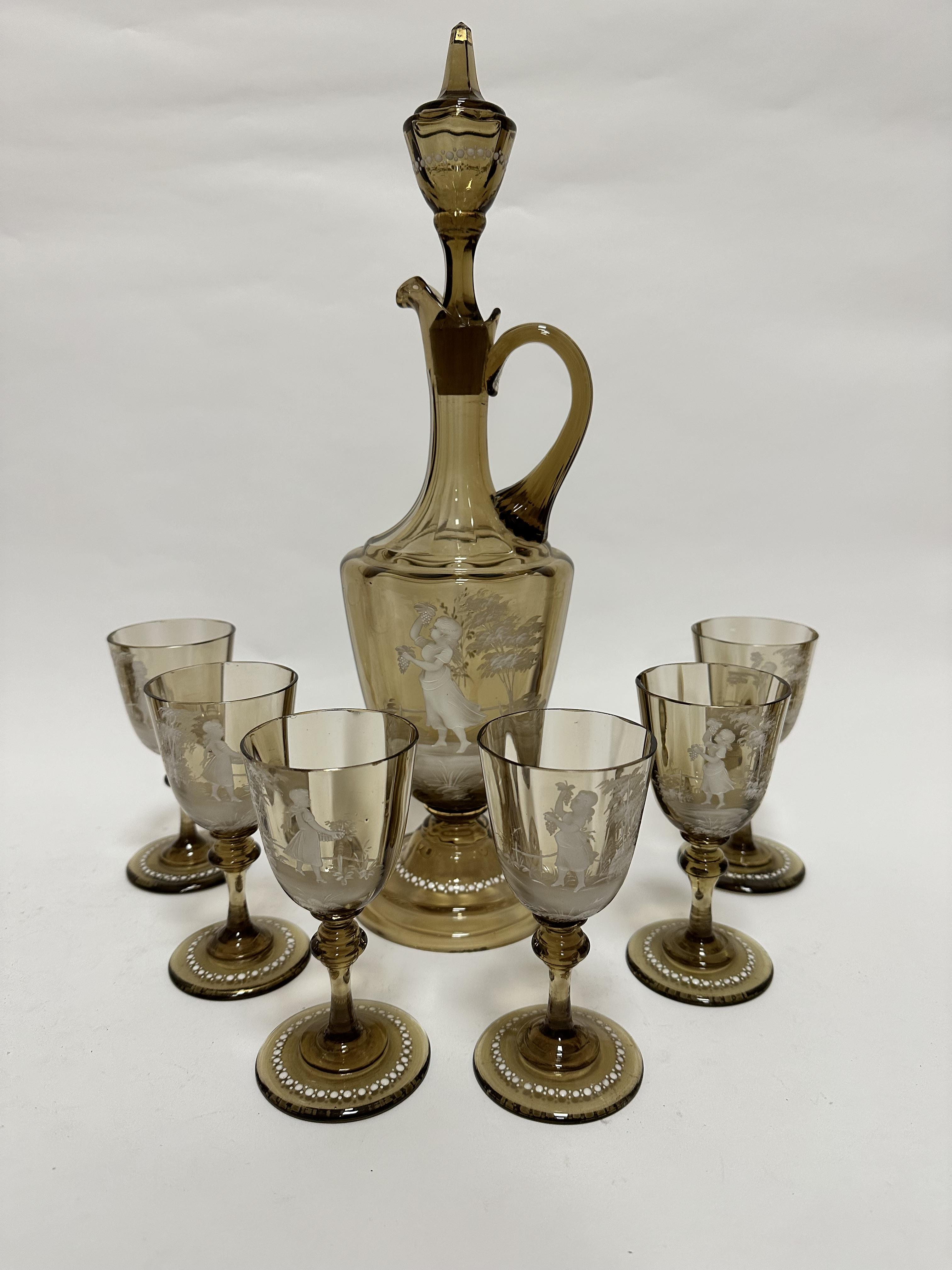 A 19thc pale amber decanter and set of six panelled glasses with Mary Gregory enamelled