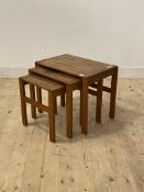 A mid 20th century teak nest of three tables, H49cm, W60cm D40cm