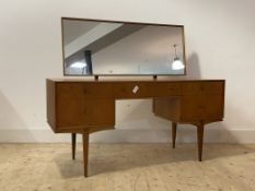 McIntosh, A mid century teak dressing table, the swing mirror over one long and four short