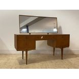 McIntosh, A mid century teak dressing table, the swing mirror over one long and four short