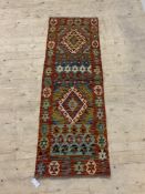 A Chobi kilim runner rug of all over geometric design, 195cm x 65cm