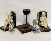 A pair of 1920s plaster cast seated boy and girl figure bookends, a/f, distressed, (17cm x 13cm),