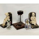 A pair of 1920s plaster cast seated boy and girl figure bookends, a/f, distressed, (17cm x 13cm),