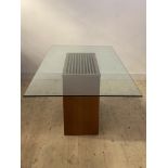 A large contemporary dining table, the glass top raised on a veneered walnut rectangular pedestal