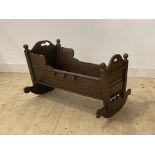 An early 19th century oak crib of jointed construction, H63cm, W94cm, D70cm