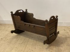 An early 19th century oak crib of jointed construction, H63cm, W94cm, D70cm