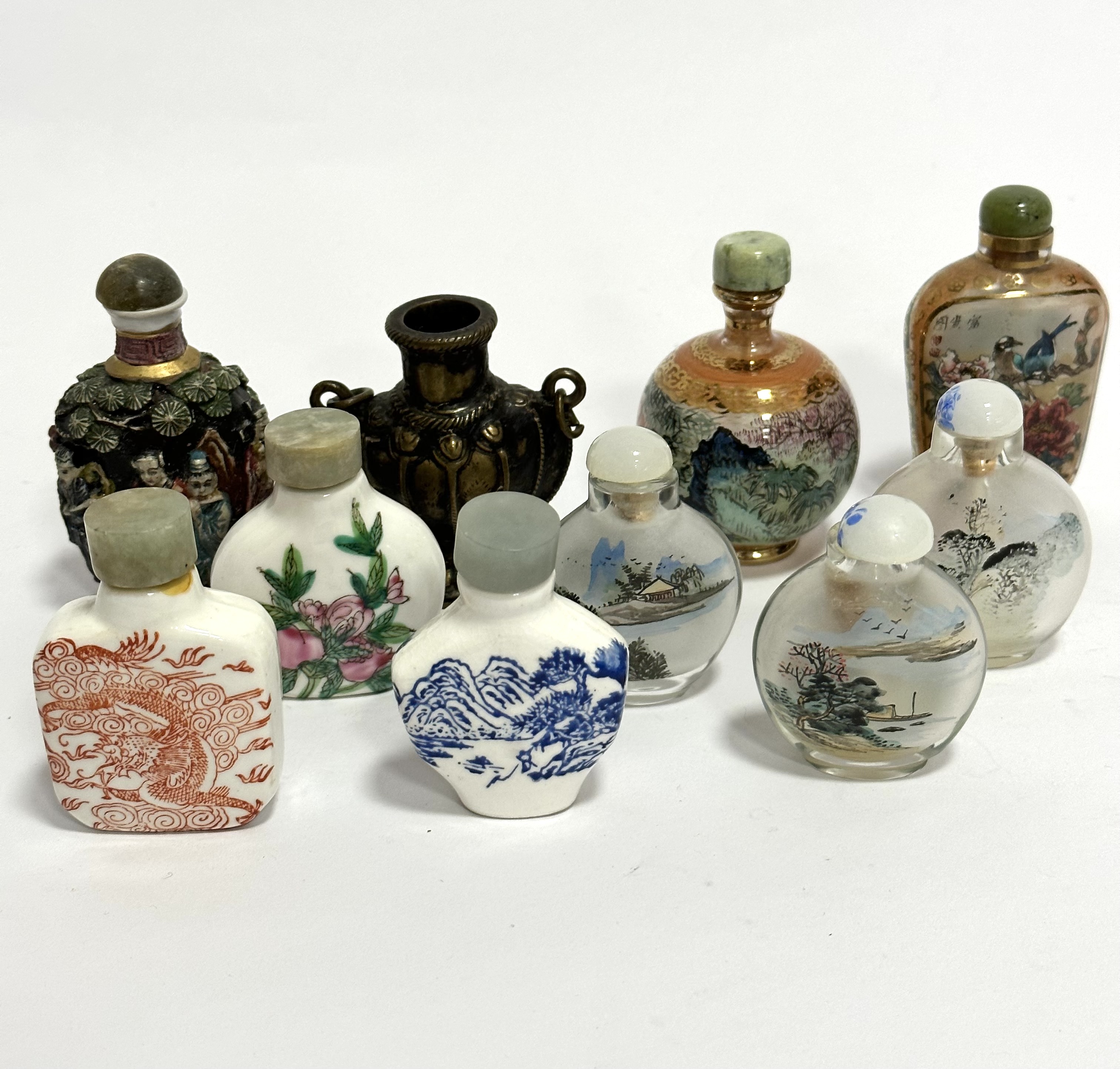 Four various ceramic modern Chinese snuff bottles with transfer printed and enamelled decoration,