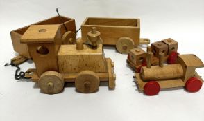 A treen child's model steam engine with two carriages and a smaller treen steam engine with carriage
