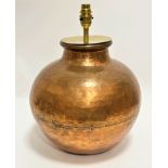 A Middle Eastern soldered two-section copper hammered cooking pot with later brass mounted light