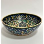 A late 19th early 20thc Moorish style bowl decorated with stylised flower and leaf design, chip to