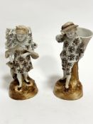 A pair of Continental porcelain figures, The Grape Harvesters, decorated with brown and gilt