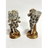 A pair of Continental porcelain figures, The Grape Harvesters, decorated with brown and gilt