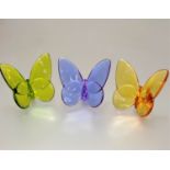A set of three Baccarat coloured glass butterflies of peridot, amethyst and citrine coloured
