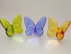 A set of three Baccarat coloured glass butterflies of peridot, amethyst and citrine coloured