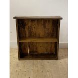 An early 20th century oak open bookcase, with floral carved bands and one adjustable shelf, H82cm,