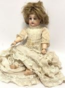 A late 19thc Simon & Halbig German bisque head doll with flirty eyes and open mouth, with