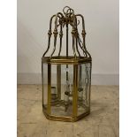 A Gilt brass hexagonal hall lantern, with inset bevelled plates enclosing four branches, H75cm