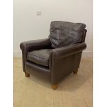 A Modern leather upholstered easy chair, raised on turned oak supports, H90cm, W81cm, D91cm