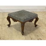 A handsome Victorian walnut stool, the upholstered top over frieze carved on each side with vacant