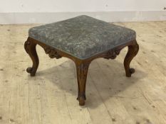 A handsome Victorian walnut stool, the upholstered top over frieze carved on each side with vacant
