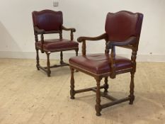 A Pair of circa 1930's oak carver chars, with studded leather upholstered seat and back, scrolled