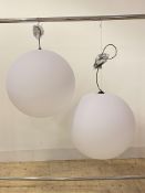 A pair of contemporary ceiling pendent light fittings, each with a large spherical moulded plastic