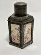A reproduction pewter octagonal Chinese panelled tea canister with landscape figures and domed