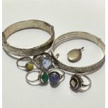 Five various white metal and silver rings, one set oval cabuchon green stone, another with