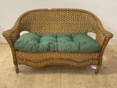 A Vintage wicker verandah two seat sofa, with squab cushion, H84cm, W150cm, D68cm