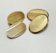 Two 9ct gold engine turned decorated oval sleeve links, (L 2cm x 1cm) weighs 8.4g