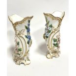 A pair of Royal Crown Derby cornucopia shaped porcelain vases decorated with floral encrusted sprays