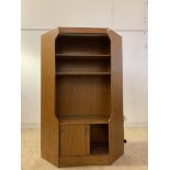 A mid century teak veneered corner unit, with illuminated interior, two shelves and sliding cupboard