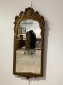 An Ornate 18th century style gilt composition framed wall hanging mirror, with scrolling pediment