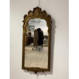 An Ornate 18th century style gilt composition framed wall hanging mirror, with scrolling pediment