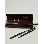 A Mont Blanc set of two black enamelled pens including a fountain pen and ball point pen, complete