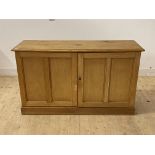 A Victorian and later pine side cabinet, the twin doors enclosing a shelf, on skirted base, H85cm,