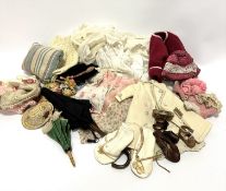 A collection of dolls clothing and accessories including two Edwardian parasols, one with lace