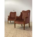 A Pair of Edwardian inlaid mahogany ladies easy chairs, upholstered, raised on square tapered