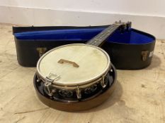 An early 20th century Ukulele banjo strung instrument, the fret with mother of pearl inlay, in a