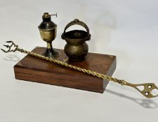 A miniature brass handled dish, a miniature brass oil lamp base, a brass toasting fork and a brass