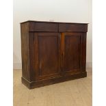A Victorian mahogany side cabinet, fitted with two frieze drawers over two doors enclosing a