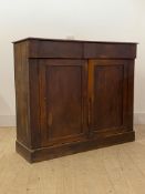 A Victorian mahogany side cabinet, fitted with two frieze drawers over two doors enclosing a