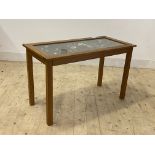 An oak Bijouterie table, the hinged glass top enclosing an old printers tray, containing a