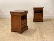 A pair of cherry bedside chests, each with moulded top over open shelf and two drawers, raised on