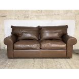 A modern sofa bed, upholstered in quality brown leather, H90cm, W200cm, D100cm