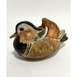 An Audrey Carter pottery handmade teal duck, signed verso, (13cm x 19cm x 11cm), one crest to head
