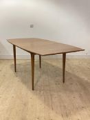 McIntosh, A mid century teak extending dining table, the shaped and moulded top with folding leaf