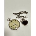 An Art Deco Continental white metal open faced pocket watch with silvered stylised engine turned