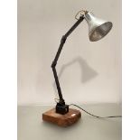 A vintage mid century articulated angle adjustable machinists lamp, with silvered conical shade,