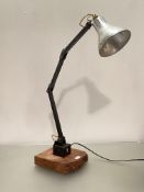 A vintage mid century articulated angle adjustable machinists lamp, with silvered conical shade,
